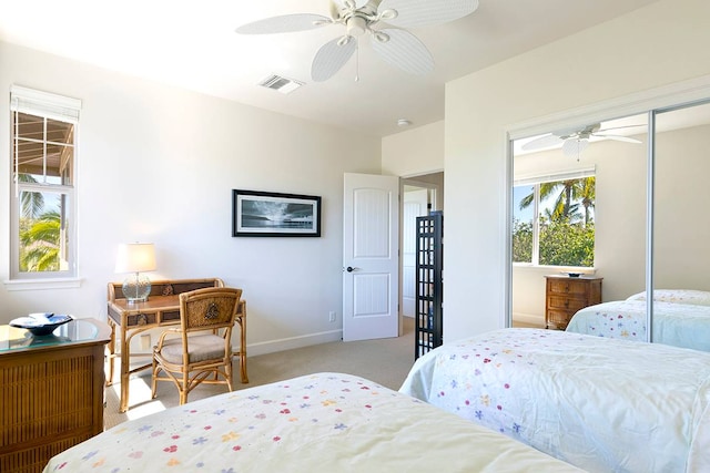 bedroom featuring light carpet, a closet, and ceiling fan
