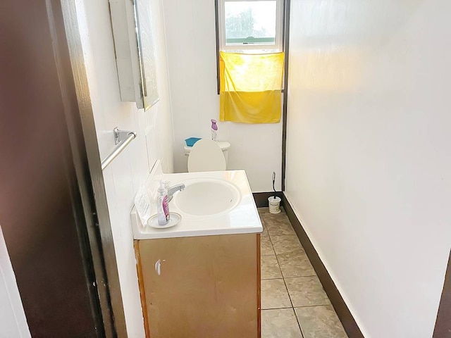 bathroom with vanity, tile floors, and toilet