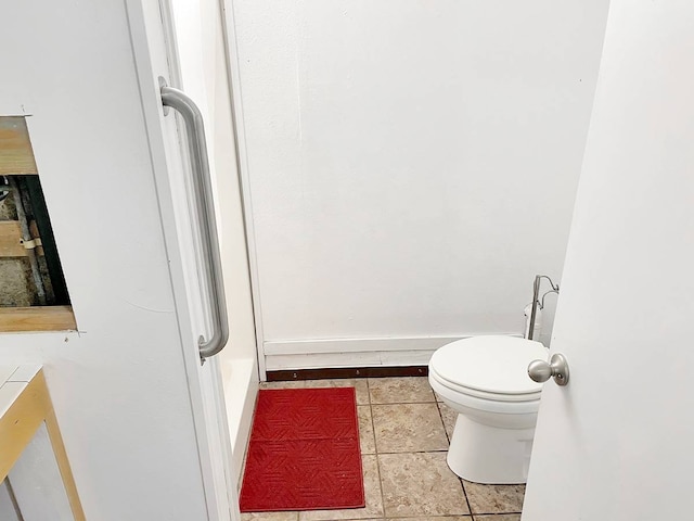 bathroom with toilet and tile flooring