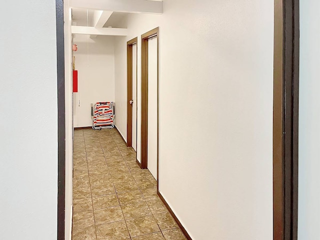 hall featuring light tile flooring