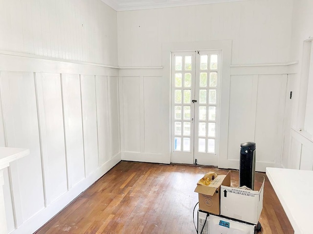 interior space with hardwood / wood-style floors and crown molding