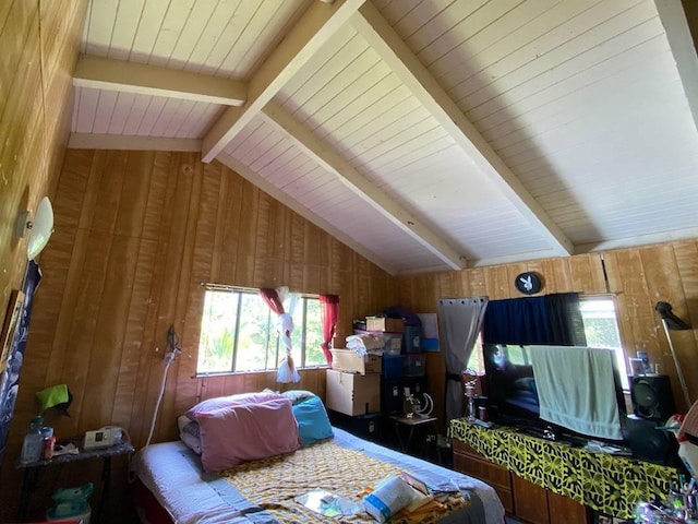 bedroom featuring wood walls and lofted ceiling with beams