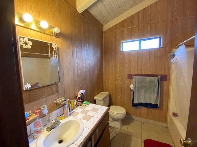 full bathroom with tile patterned flooring, vanity, wooden walls, toilet, and vaulted ceiling