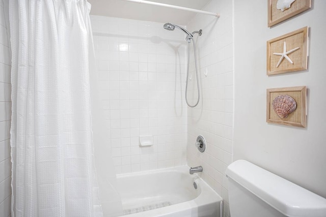 bathroom with toilet and shower / bath combo with shower curtain