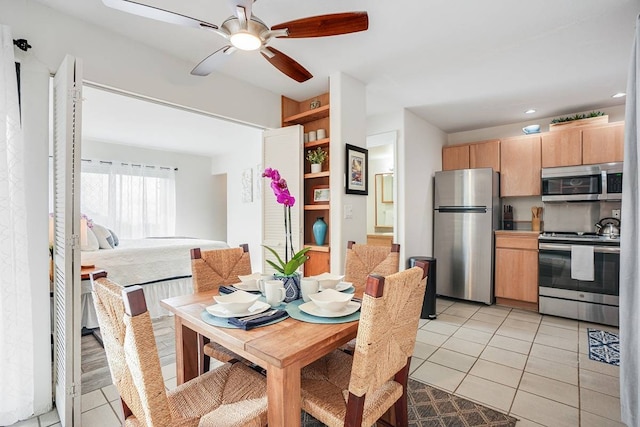 dining room featuring light tile floors and ceiling fan