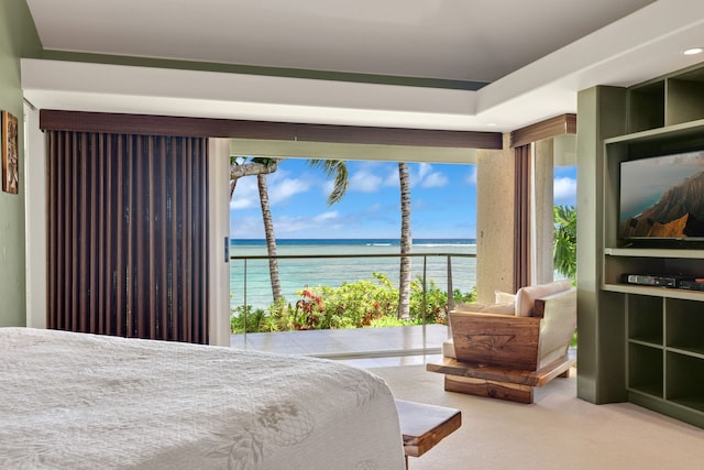 carpeted bedroom featuring a water view