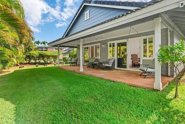 back of property featuring a patio and a lawn