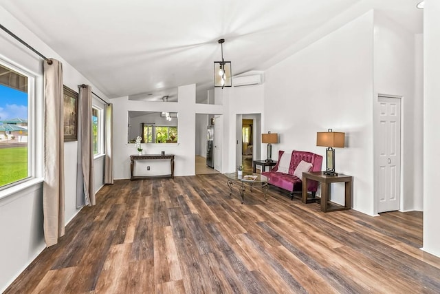 living area with a wall mounted air conditioner, dark hardwood / wood-style flooring, and lofted ceiling