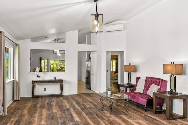 living area featuring vaulted ceiling, dark hardwood / wood-style floors, and a wall unit AC