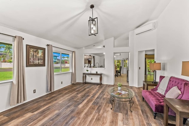 living room with high vaulted ceiling, hardwood / wood-style flooring, an AC wall unit, and a healthy amount of sunlight