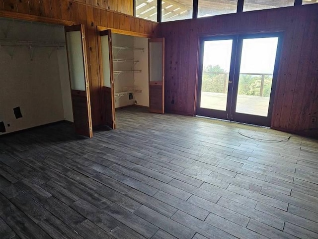 interior space featuring wood walls, a closet, and hardwood / wood-style floors