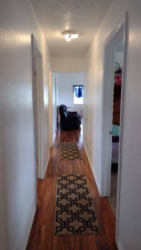 hallway with wood-type flooring