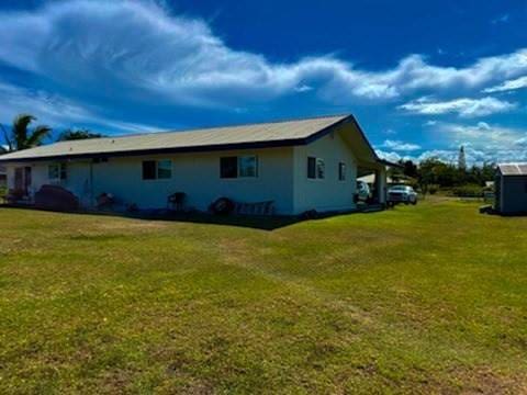 view of side of home featuring a yard