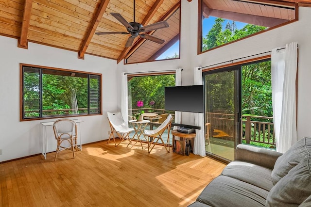 sunroom with wooden ceiling, lofted ceiling with beams, plenty of natural light, and ceiling fan