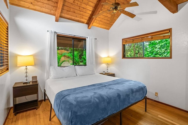 bedroom featuring vaulted ceiling with beams, ceiling fan, light hardwood / wood-style floors, and wood ceiling