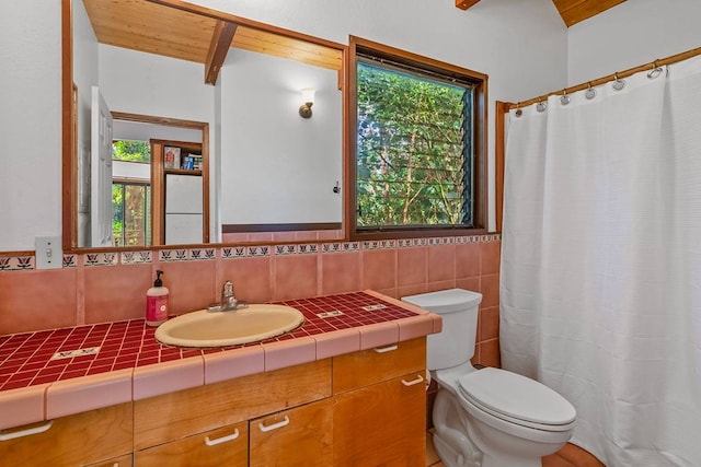 bathroom featuring tile walls, toilet, decorative backsplash, and vanity