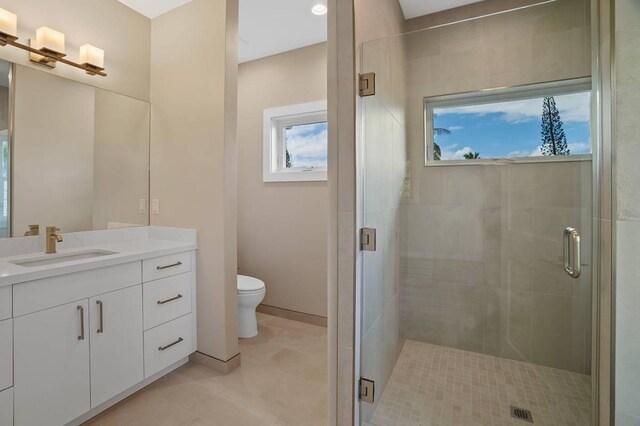 bathroom with vanity, toilet, and walk in shower