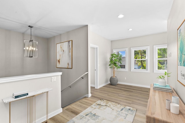 foyer with a chandelier and light hardwood / wood-style flooring