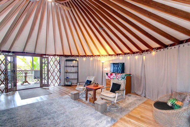 living room featuring hardwood / wood-style flooring and lofted ceiling