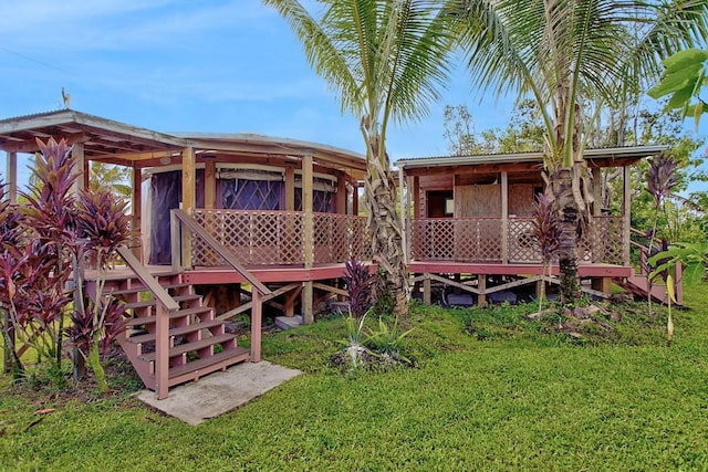 rear view of house featuring a sunroom