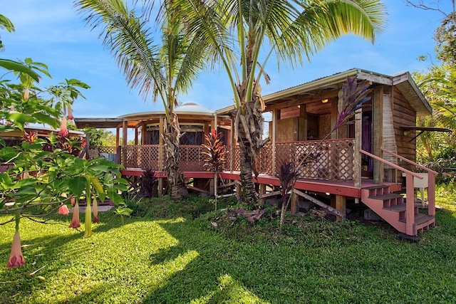 rear view of property featuring a yard