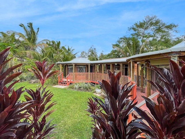 rear view of property featuring a lawn