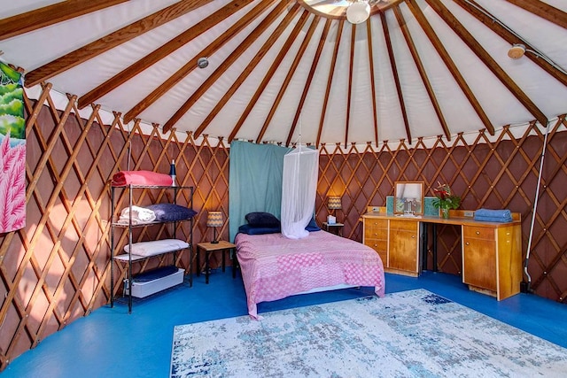 unfurnished bedroom with lofted ceiling with beams and dark carpet