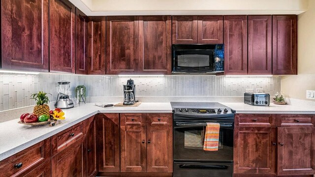 kitchen featuring tasteful backsplash and black appliances