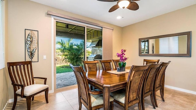 dining space with ceiling fan and light tile patterned floors