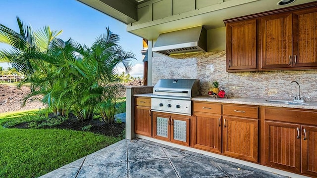 view of patio with an outdoor kitchen, a grill, and sink