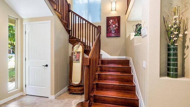 stairway with tile patterned flooring