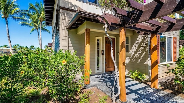 entrance to property featuring a pergola