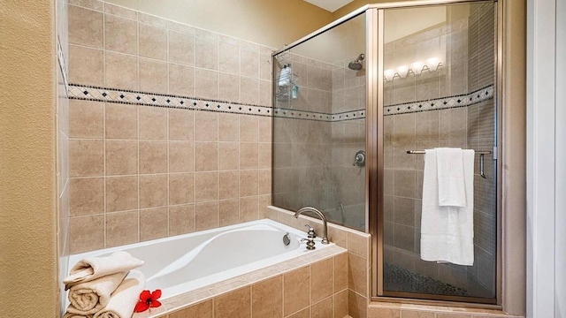 bathroom with separate shower and tub