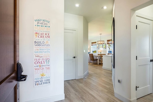 hallway with light hardwood / wood-style floors