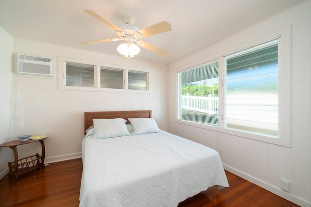 bedroom with dark hardwood / wood-style flooring, ceiling fan, and a wall mounted air conditioner