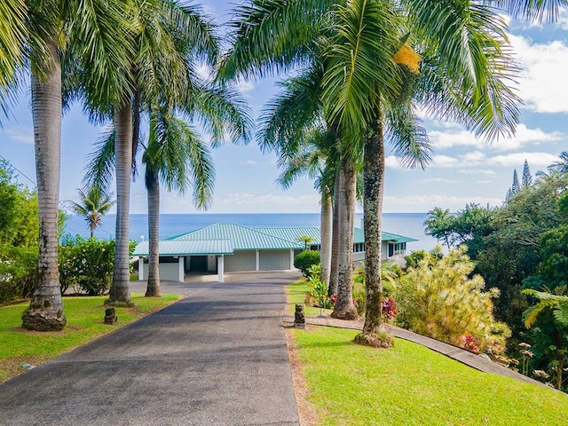 view of front of home featuring a water view and a front lawn