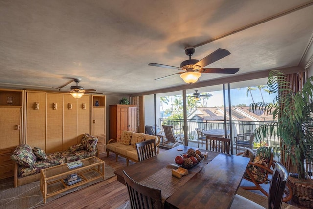 dining space with ceiling fan and dark wood-type flooring