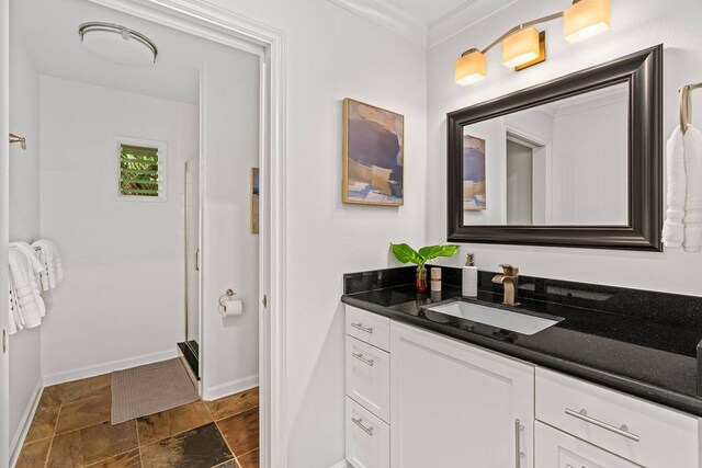 bathroom featuring ornamental molding, tile floors, and vanity