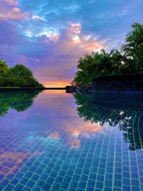 pool at dusk with a water view