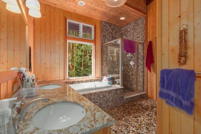 bathroom featuring vanity, wood walls, wooden ceiling, and plus walk in shower