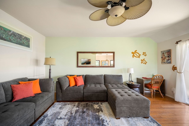 living room featuring lofted ceiling, a wealth of natural light, wood finished floors, and a ceiling fan