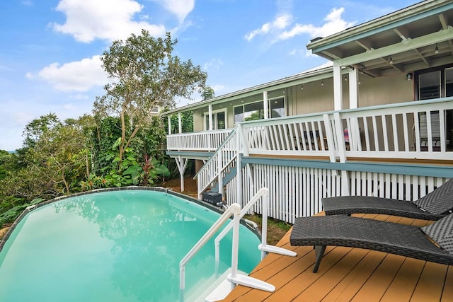 view of swimming pool with a wooden deck