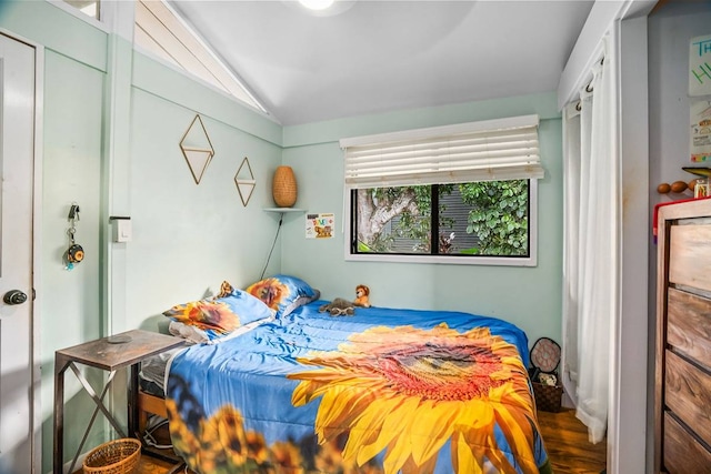 bedroom featuring vaulted ceiling and hardwood / wood-style flooring