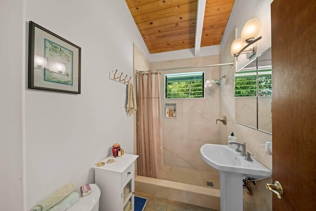 bathroom featuring curtained shower, lofted ceiling with beams, tile patterned floors, toilet, and wood ceiling