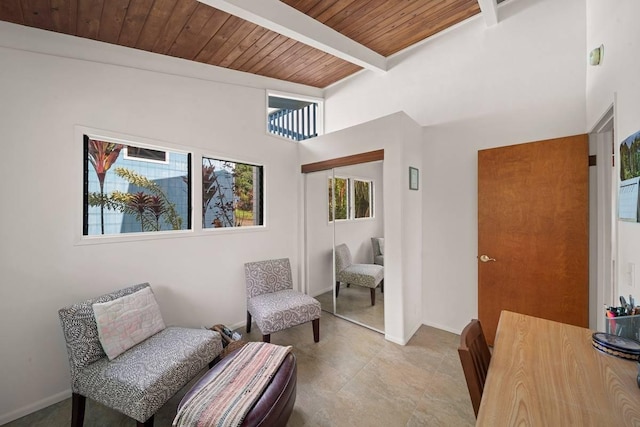 living area featuring beamed ceiling, wood ceiling, and light tile patterned floors