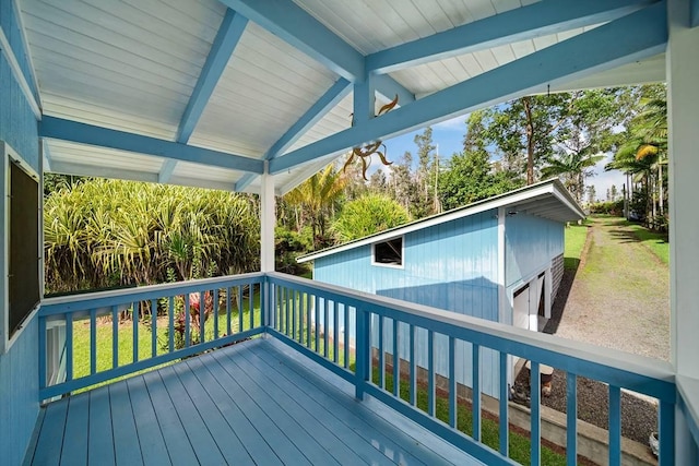 wooden terrace featuring a lawn