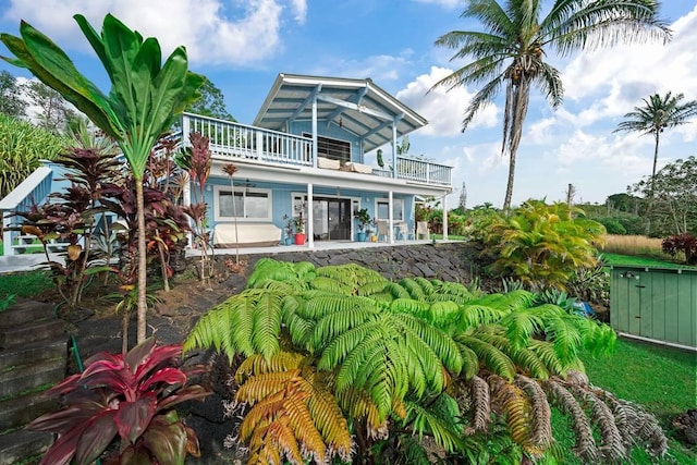 back of house featuring a patio area and a balcony