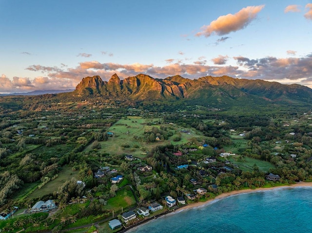 aerial view at dusk featuring a mountain view