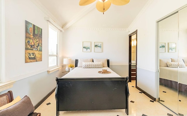 bedroom featuring ceiling fan, ornamental molding, a closet, and vaulted ceiling with beams