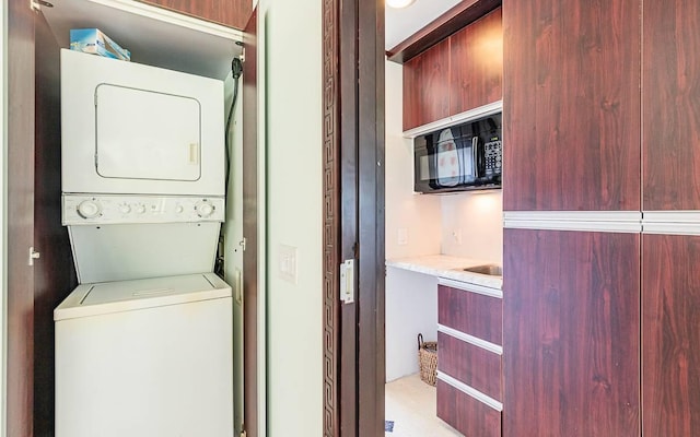 laundry room with stacked washer / drying machine